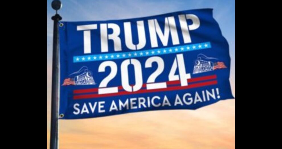 A close-up of a Trump 2024 flag, with the words "Trump 2024" in bold letters and an American flag in the background.