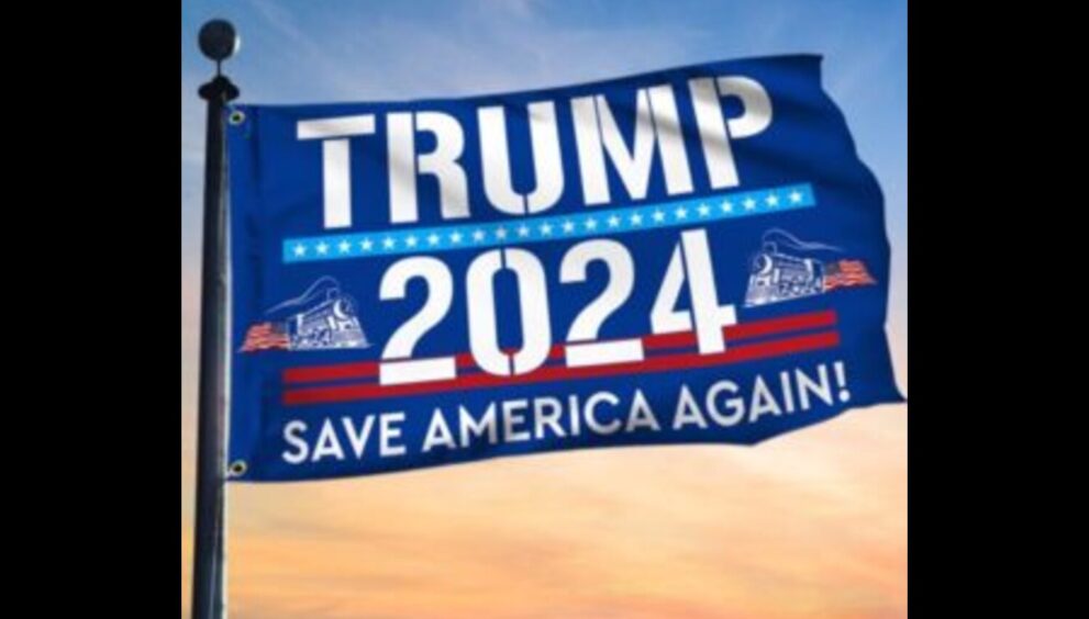 A close-up of a Trump 2024 flag, with the words "Trump 2024" in bold letters and an American flag in the background.