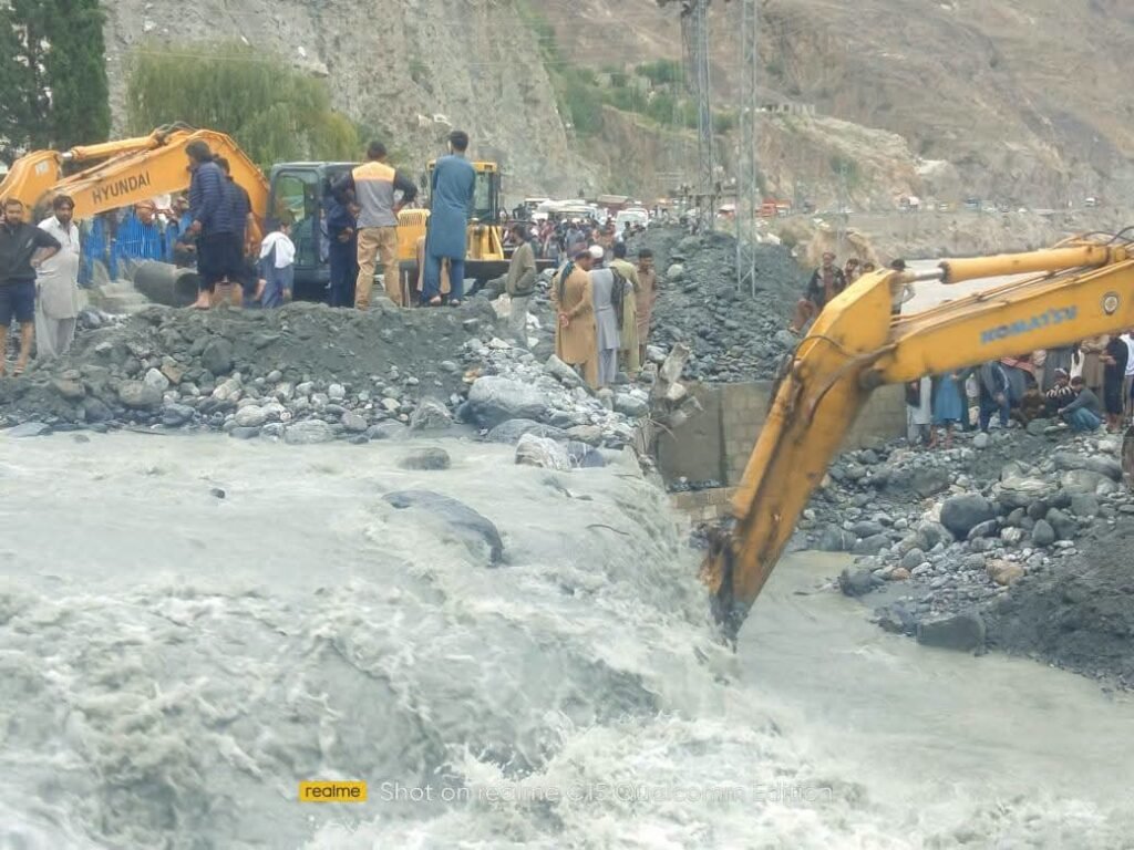 Heavy machinery being used to remove debris from roads after floods triggered landslides