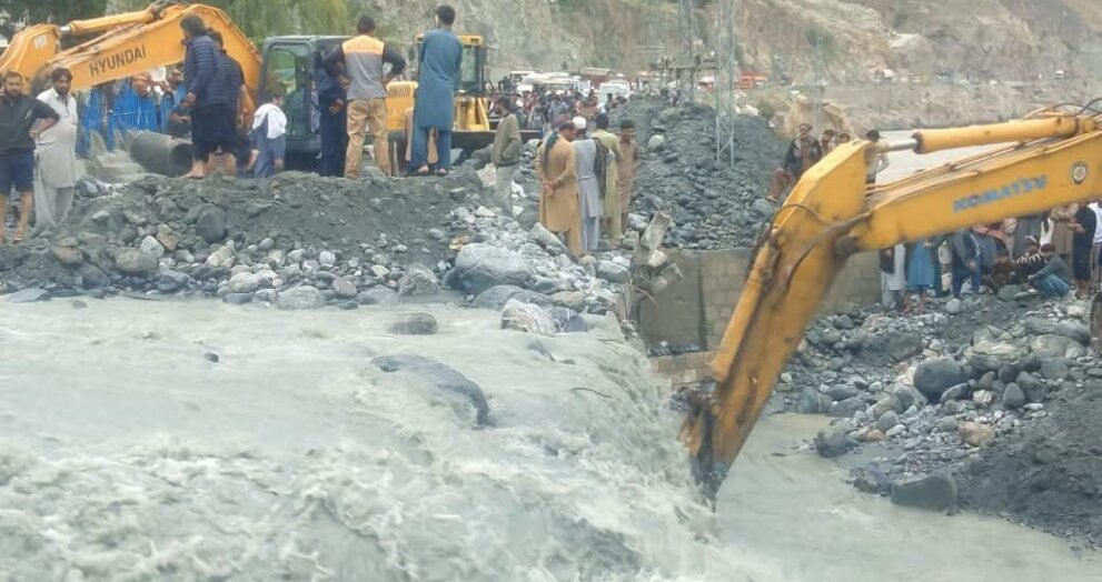 Heavy machinery being used to remove debris from roads after floods triggered landslides