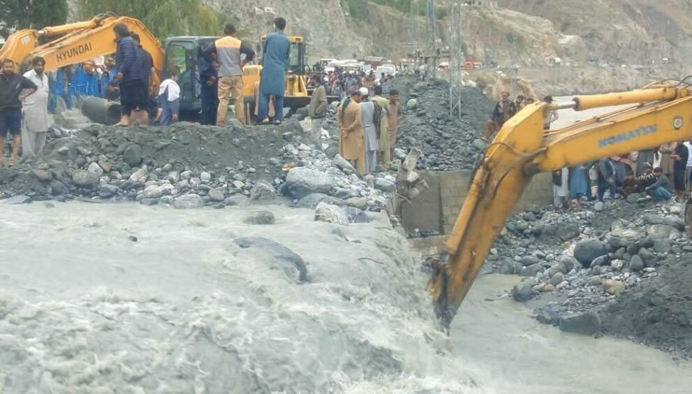 Heavy machinery being used to remove debris from roads after floods triggered landslides